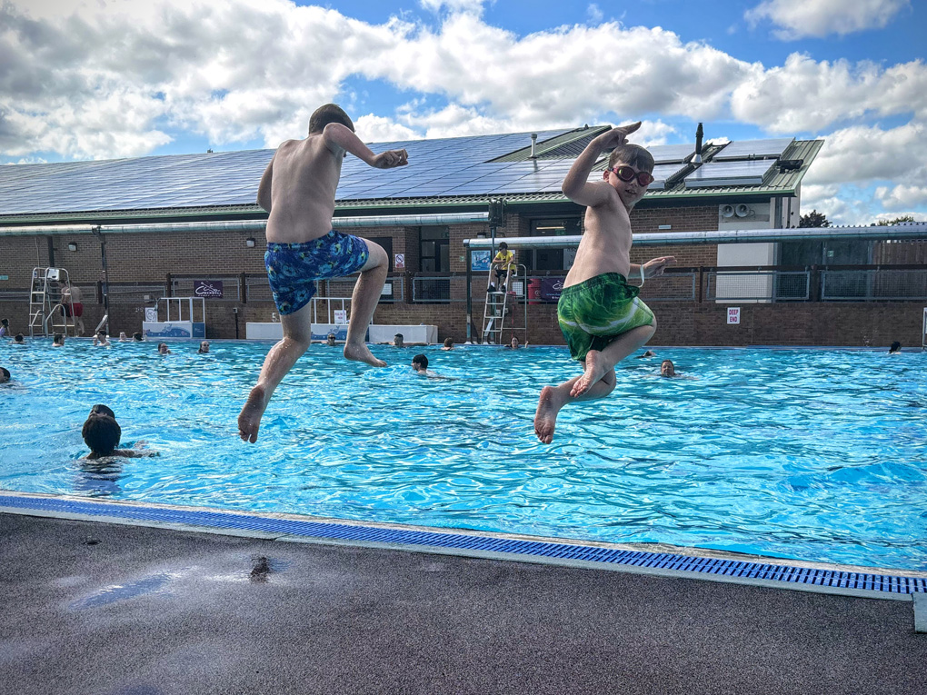 Image of Josh and Jack in the air about to take another big splash in the pool!