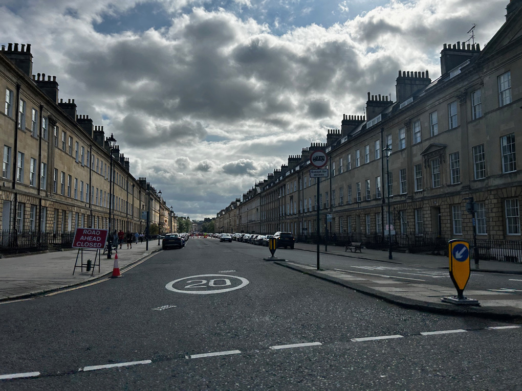 A view of a closed Bath street with celebrations in the distance