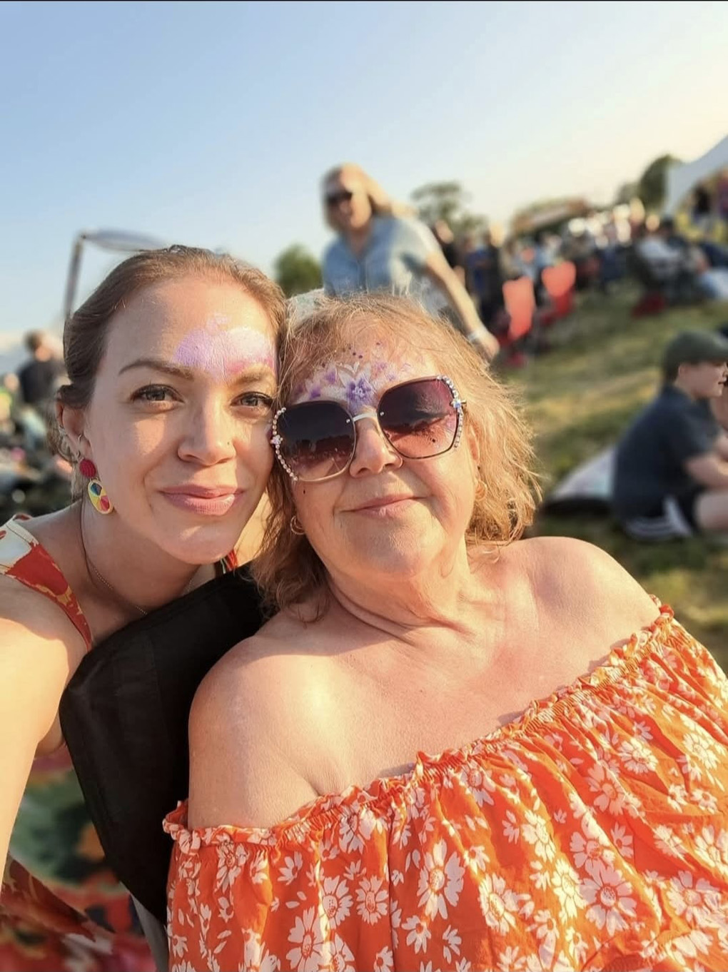Picture of two smiling ladies at a festival