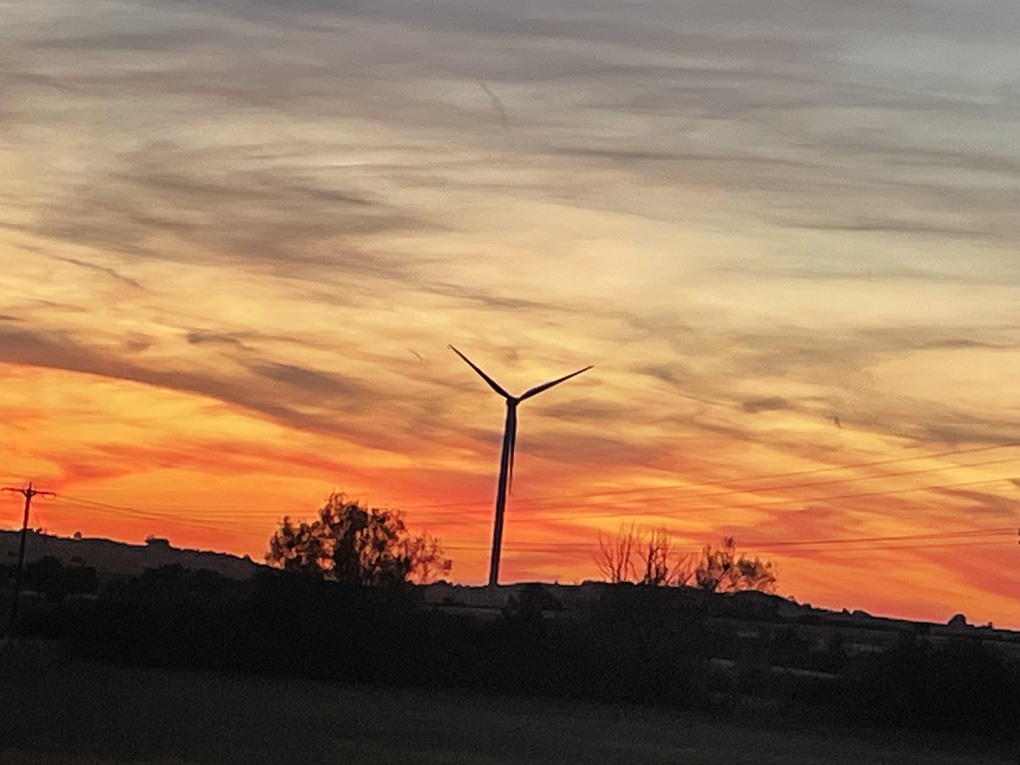 A lovely sunset with a wonderful wind turbine in the foreground.