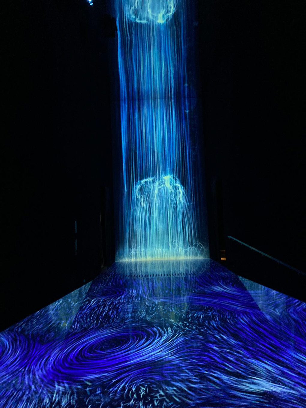 Blue lights representing a waterfall in the dark