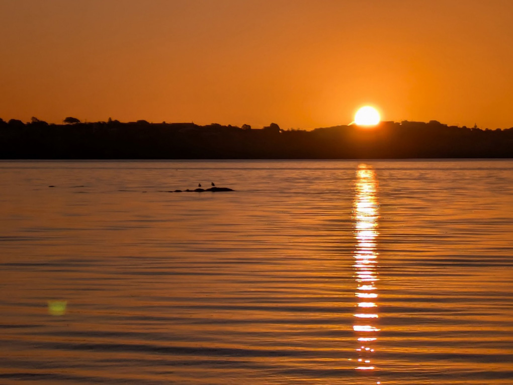 sunset over still water