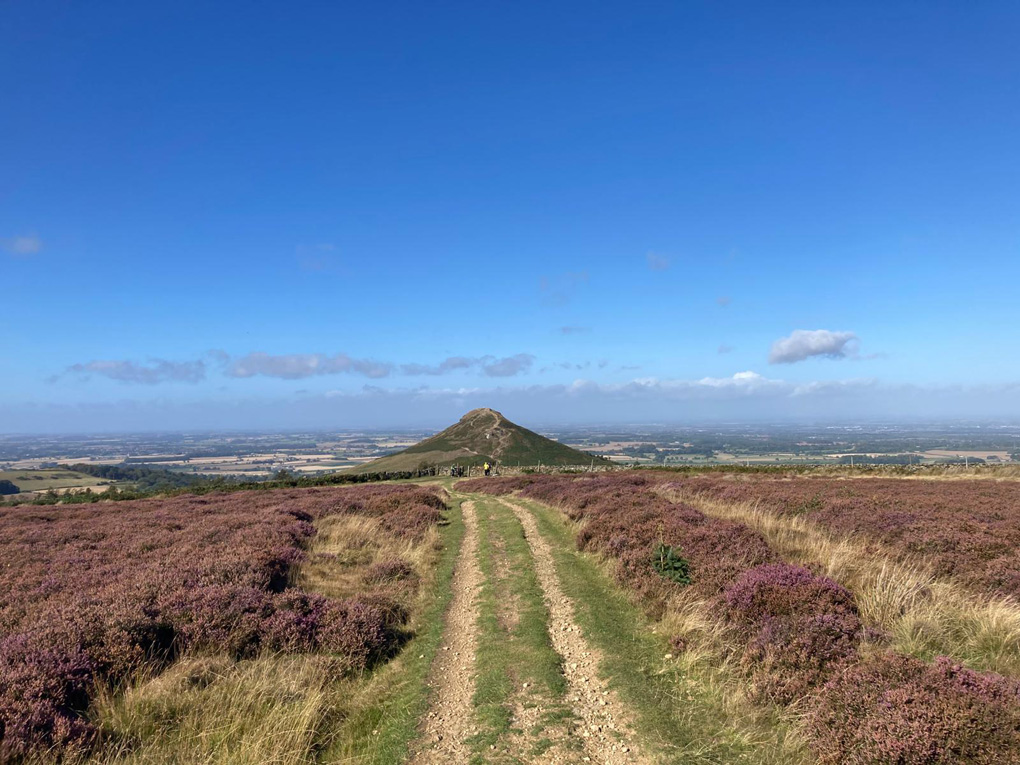 Big hill rising from a flat landscape on a sunny day