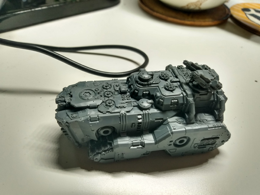 A grey plastic tank sits on my desk