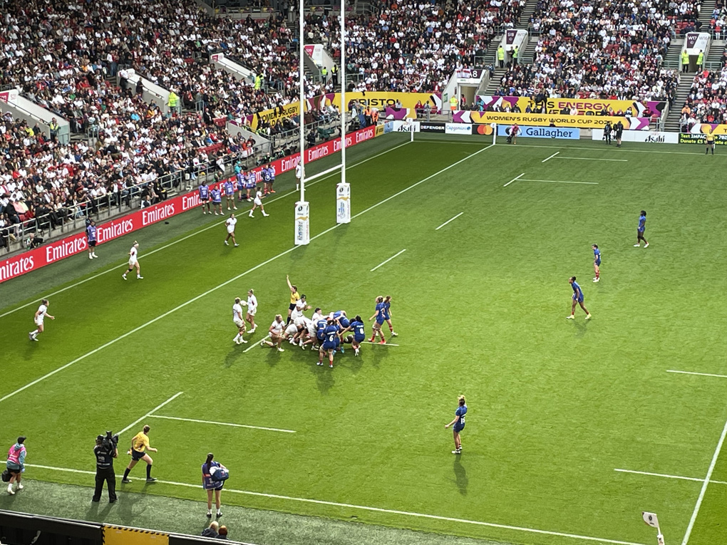 Shot of a rugby pitch in the middle of a big stadium with a scrum