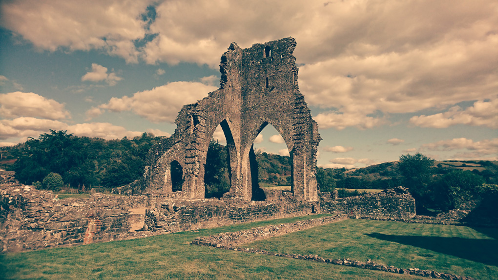 The very tall ruin of the remnant of Talley Abbey three stories high, which was built by the White Canon monks also called Premonstratensians. Three arches remain. Quite impressive sitting overlooking beautiful countryside and a lake.