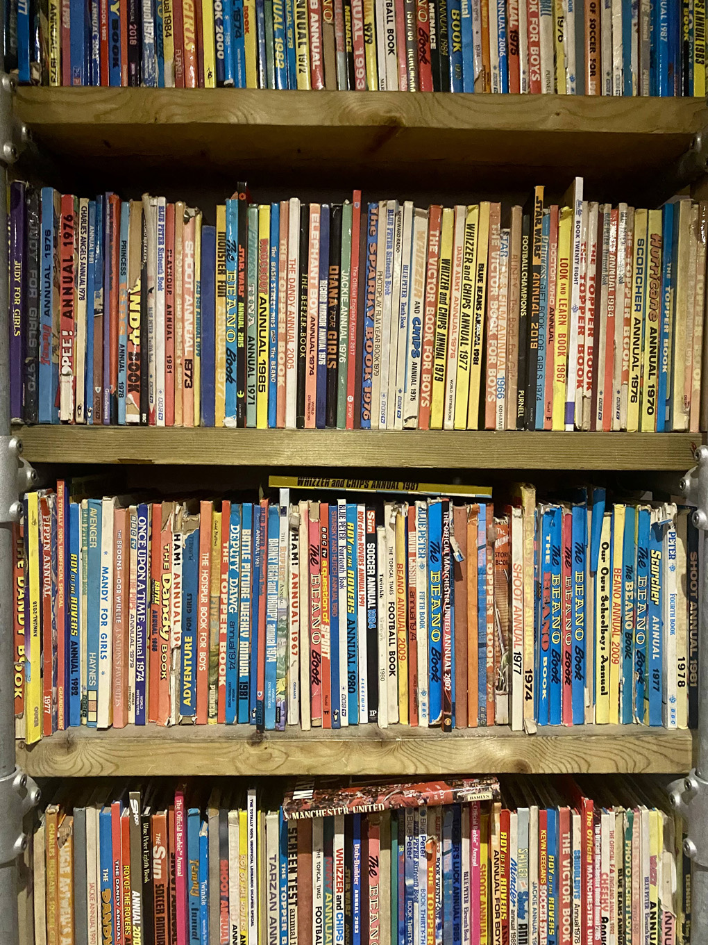 Bookshelves full of comic book annuals from the 1960s and onwards
