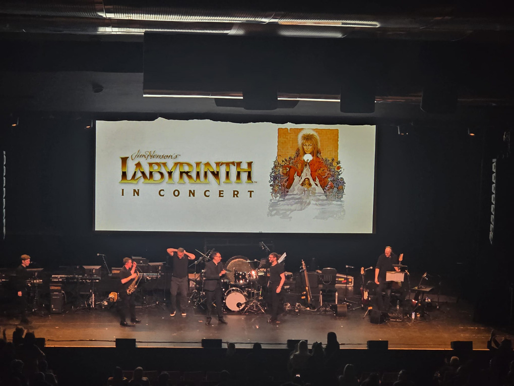 Band on stage under a 