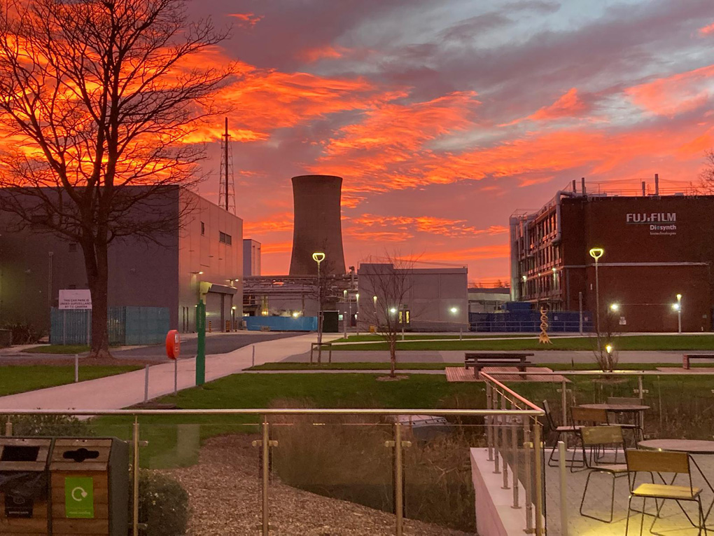 Red and orange sunset over an industrial plant