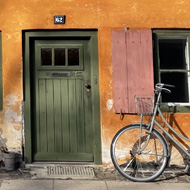 Yellow building with bikes on the side.