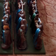 Small plastic models emerge from the woods into the flank of some other small models