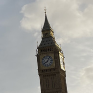 Parliament square surrounded by flags on the Commonwealth with Big Ben in the background