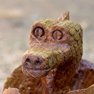 Made from polished oak the images shows a baby dragon's head emerging from an egg.