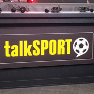 Audio and cameras with talkSPORT presentation desk, in front of stage set for Eubank/Benn boxing weigh-in media event.