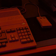 An Amiga 500 under a sign describing the wonders of gaming in 1987