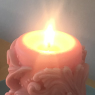 X4 handmade candles of various shapes and colours, all lit.