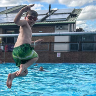 Image of Josh and Jack in the air about to take another big splash in the pool!