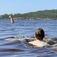 A person swimming away from the camera.