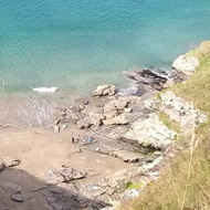 View down the cliffs to the beach from the South West coast path