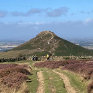 Big hill rising from a flat landscape on a sunny day