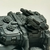 A grey plastic tank sits on my desk