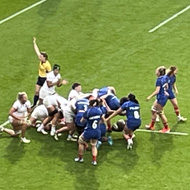 Shot of a rugby pitch in the middle of a big stadium with a scrum