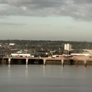 A placid River Mersey under a moody sky in Liverpool, with various sizes of boats.