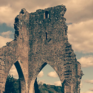 The very tall ruin of the remnant of Talley Abbey three stories high, which was built by the White Canon monks also called Premonstratensians. Three arches remain. Quite impressive sitting overlooking beautiful countryside and a lake.