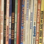 Bookshelves full of comic book annuals from the 1960s and onwards