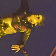 An aerial performer at the top of a rope after spinning for her life