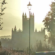 Sun setting silhouetting a church in Bath