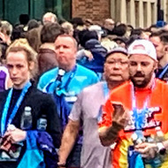 Photo of my wife in a huge crowd having just finished the Oxford half marathon in a personal best time, hands in the air with a look of elation on her face, having finally finished months of training!