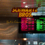 A woman steps out of Schwartz burgers in Bath, on the phone. The burger joint is lit in bright neon contrasting with the sharp shadow lines. It looks cool, 80s, and tasty as fuck.