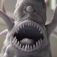 A grey 3D-printed model of a roper: a toothed rock with a single eye and flailing tentacles.