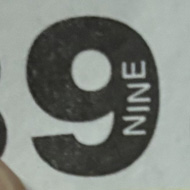 A hand holding a small paper ticket with the number 898 printed on it in large black letters