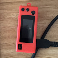 Small digital camera on a desk next to records and a coaster