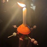 A Christingle orange and candle with sweets etc
