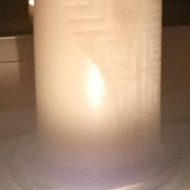 4 picture collage consisting of: a classical guitar; sheet of music; lit candle on the windowsill, dark night sky with a firework in the distance; sunset sky.