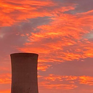 Red and orange sunset over an industrial plant