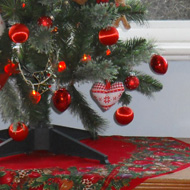 Decorated Xmas tree with heap of discarded wrapping beneath.