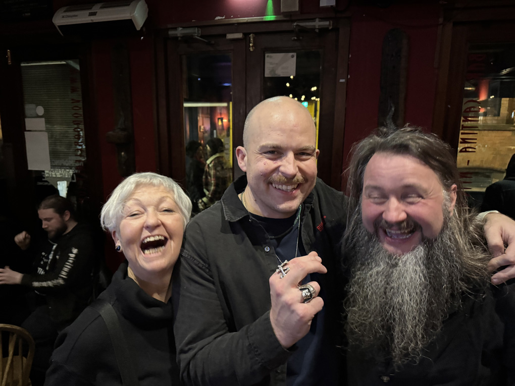 Three people celebrating at the pub