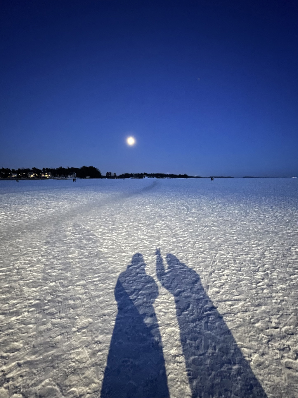 Wintery evening scene with two shadows.