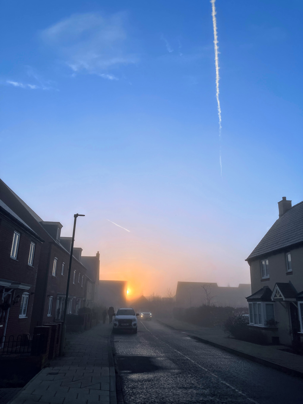 The winter sun cuming over the houses in the distance on a cold and frosty morning in January.