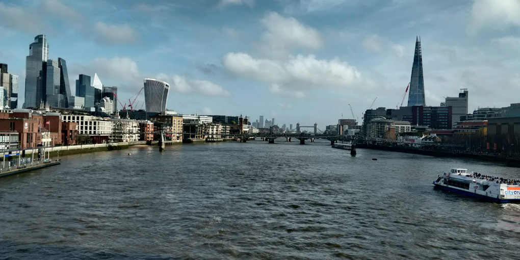 View along the Thames from London Blackfriars station, with Docklands and Tower Bridge in the distance.