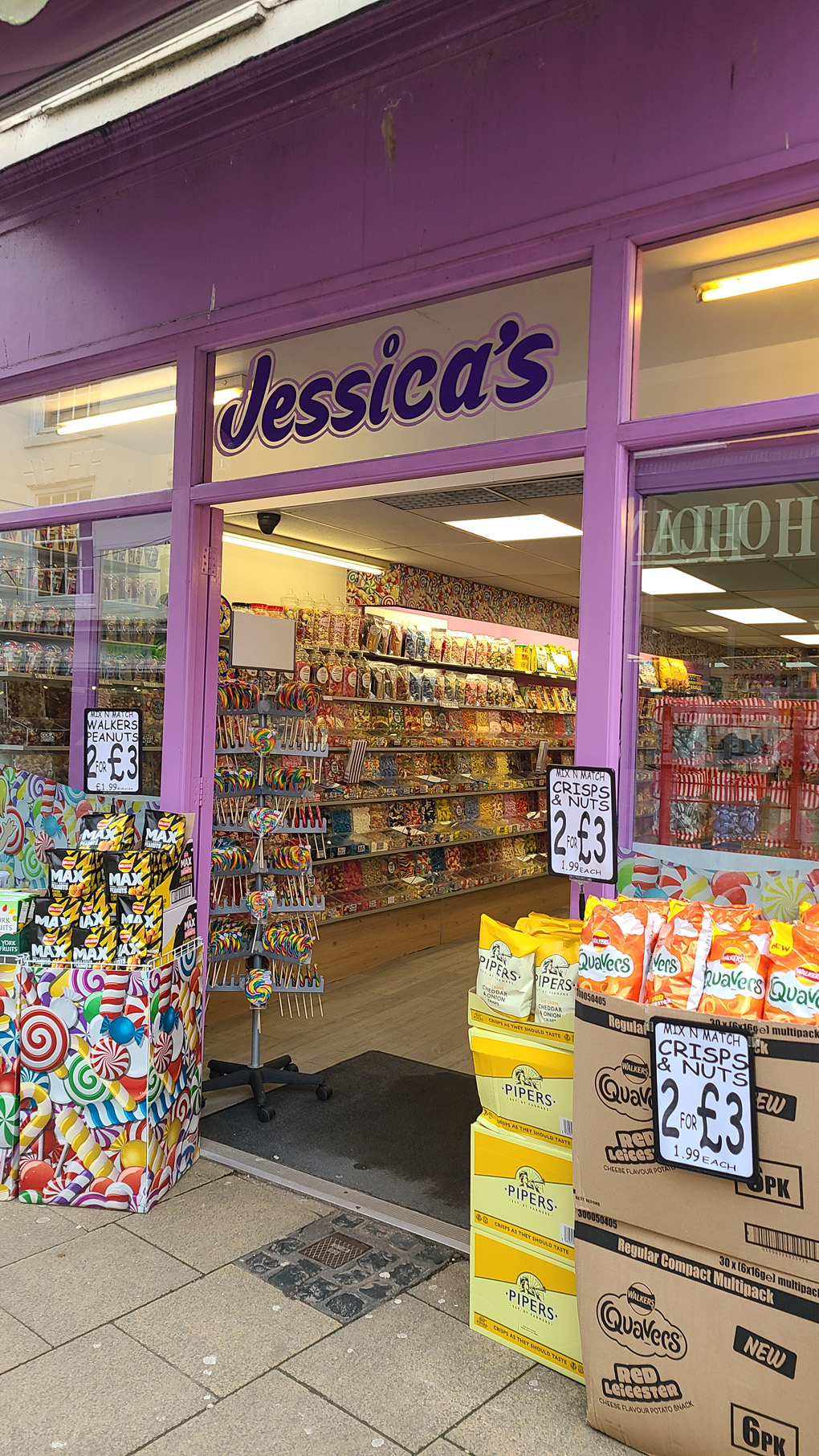 A purple fronted sweet shop with the name Jessica's, lots of sweets everywhere.