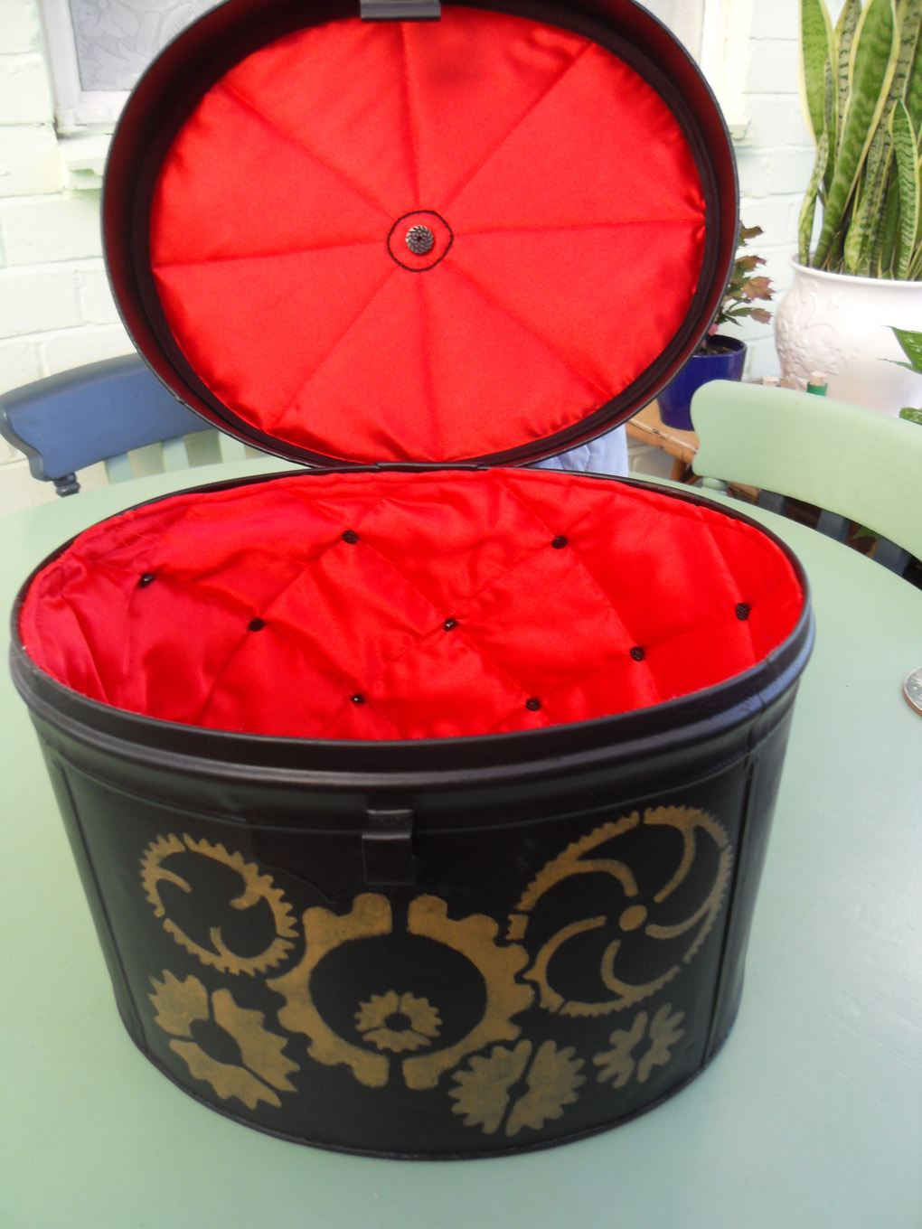 Vintage tin hat box decorated and lined with a steam punk theme.