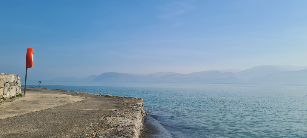 View of Snowdonia mountains across a calm sea