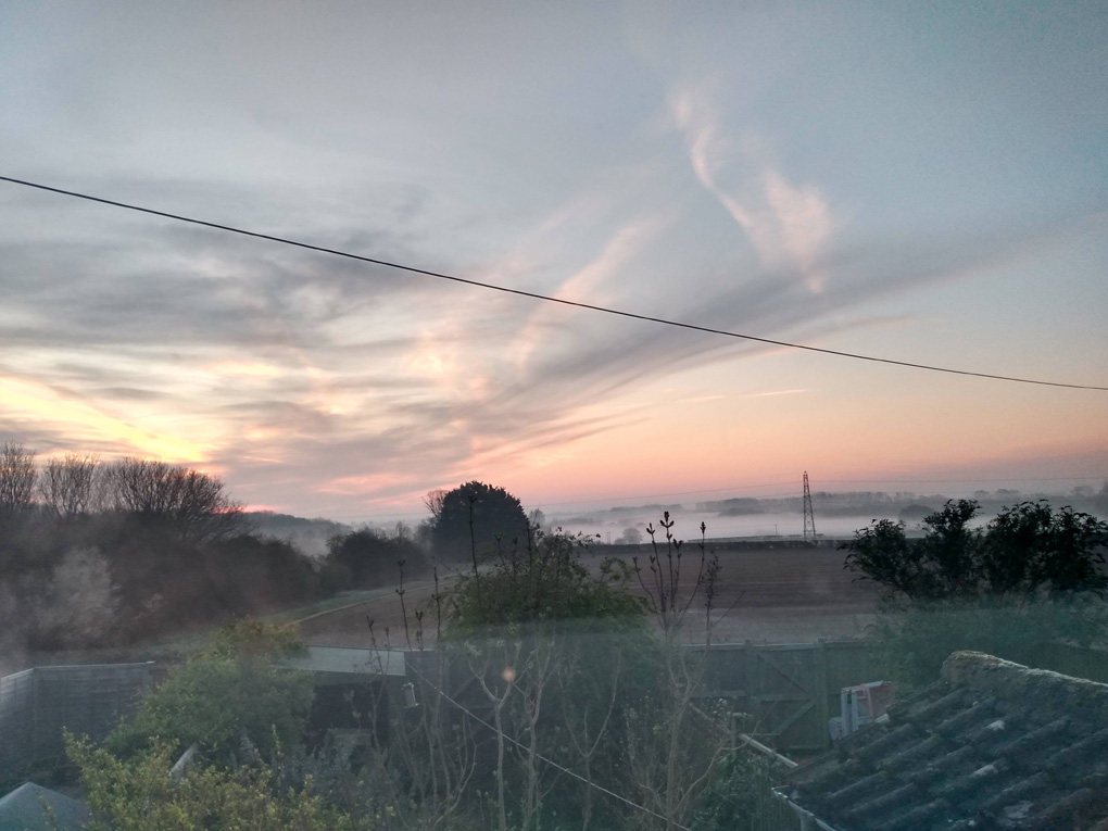 The sunrise peers through a misty morning