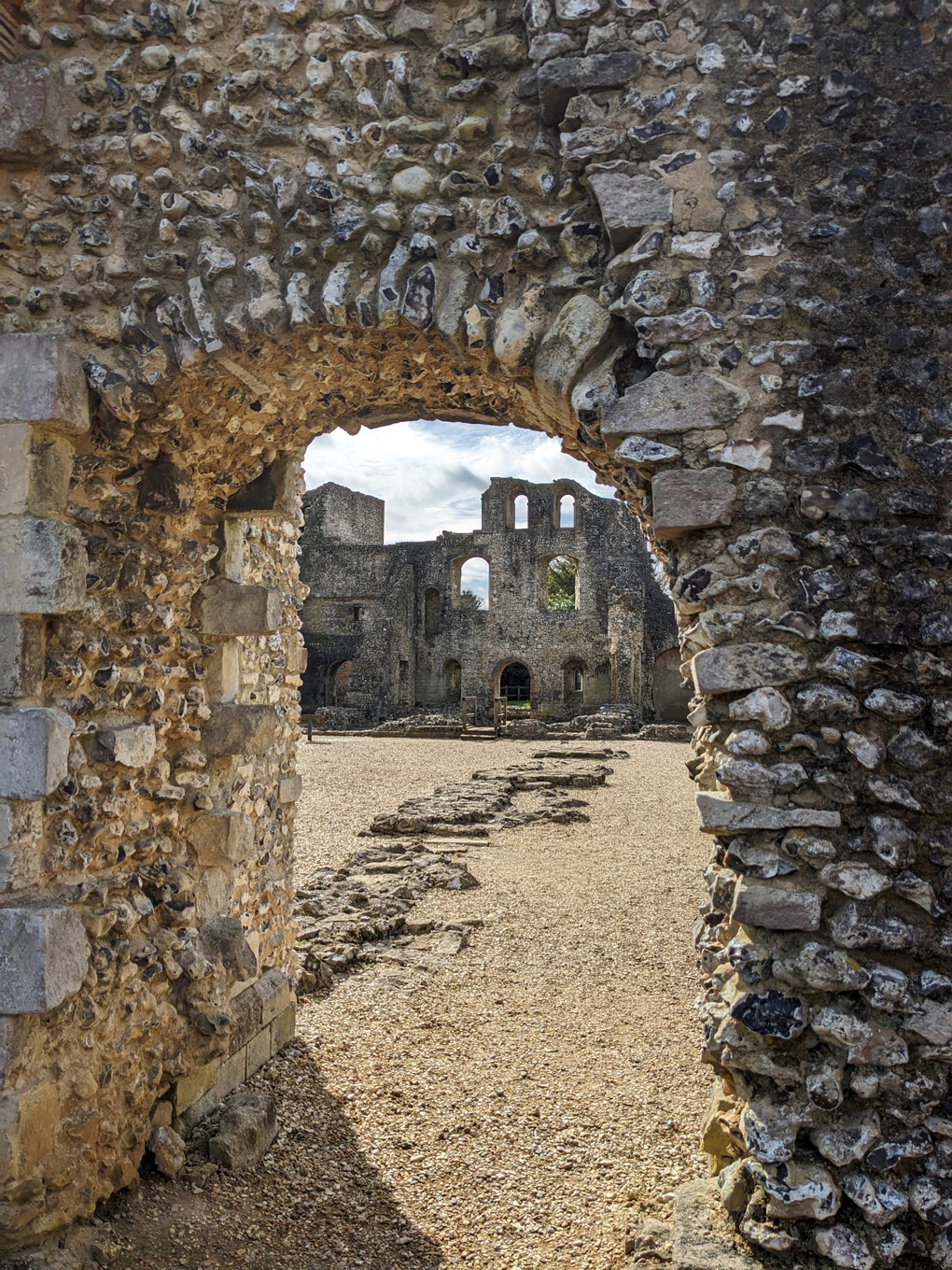Ruins viewed through a rough stone archway