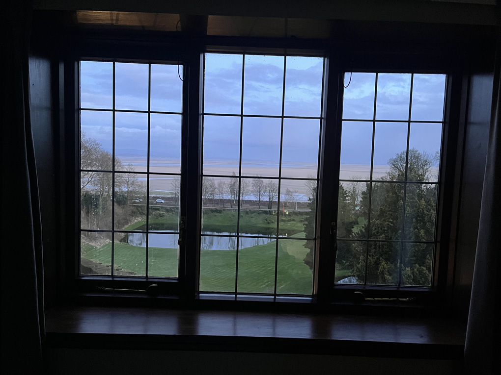 A twilight view of the sands framed by a hotel window